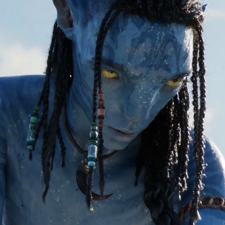 a man with dreadlocks and yellow eyes in avatar