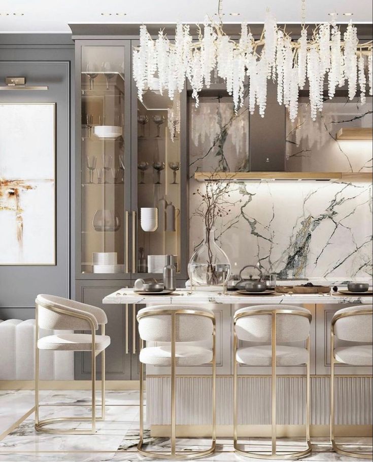 an elegant kitchen with marble counter tops and white chairs, chandelier hanging from the ceiling