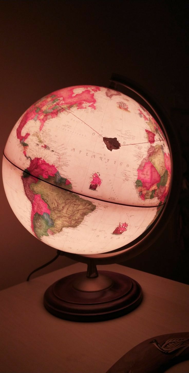 an illuminated globe sitting on top of a table