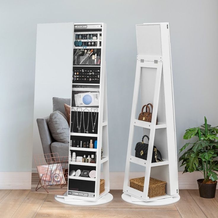 two white shelving stands in front of a mirror