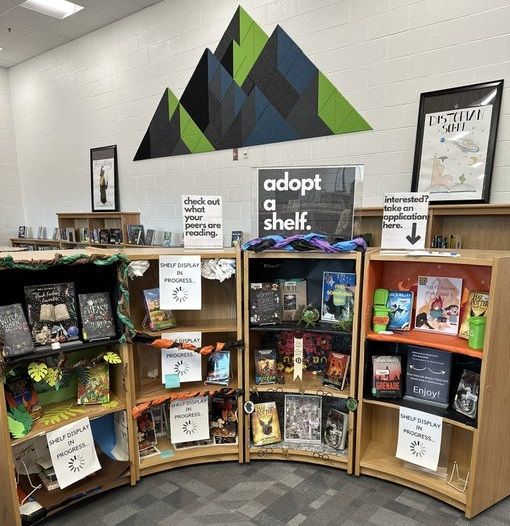 several bookshelves with signs and pictures on them in a room that looks like a library