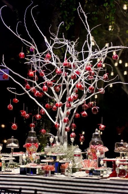 a table topped with lots of desserts and candy covered trees filled with candies