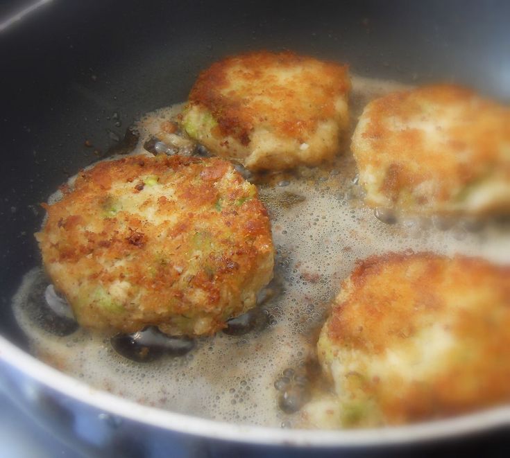 some food is cooking in a pan on the stove burners and it appears to be fried