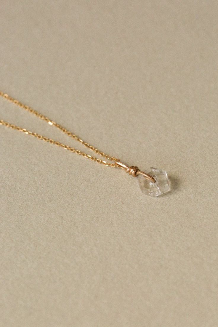 Antique crackled glass bead wrapped in 14k gold and strung on a delicate 14k gold chain. Chain is available 16" or 18" long * We love using vintage elements such as glass beads. This also means that they are each unique in their tone, shape, chips and inclusions. Elegant Faceted Jewelry In Recycled Gold, Elegant Recycled Gold Faceted Jewelry, Formal Briolette Jewelry With Delicate Chain, Elegant Yellow Gold Wire Wrapped Necklace, Delicate Yellow Gold Crystal Necklace Gift, Sterling Silver Yellow Gold Wire Wrapped Necklaces, Yellow Gold Wire Wrapped Pendant Jewelry, Wire Wrapped Yellow Gold Pendant Jewelry, Faceted Yellow Gold Jewelry In Recycled Gold