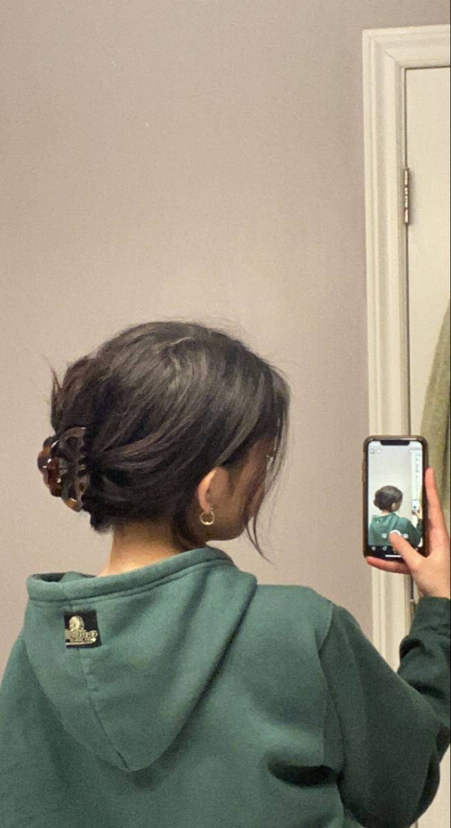 a woman taking a selfie in front of a mirror