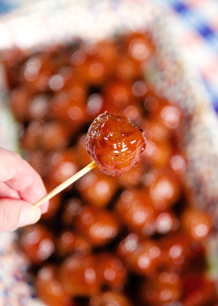 a person holding a stick with some food on it