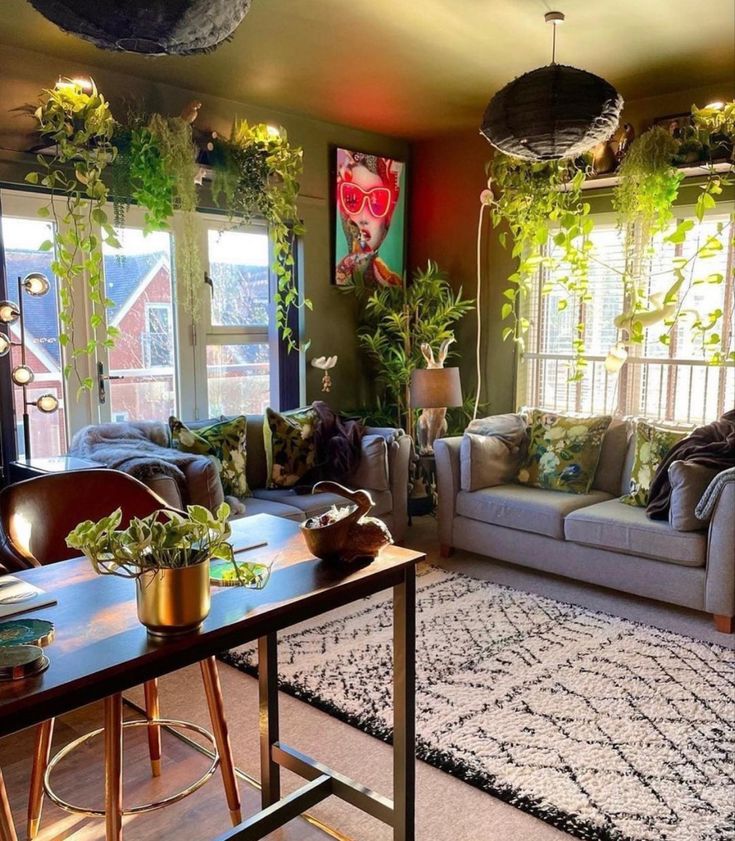 a living room filled with lots of furniture and plants on top of the couches