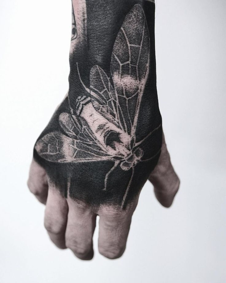 a man's hand with a tattoo on it