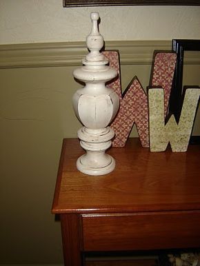 a white lamp sitting on top of a wooden table next to letter shaped magnets