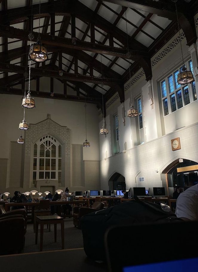 the inside of a large building with tables and chairs