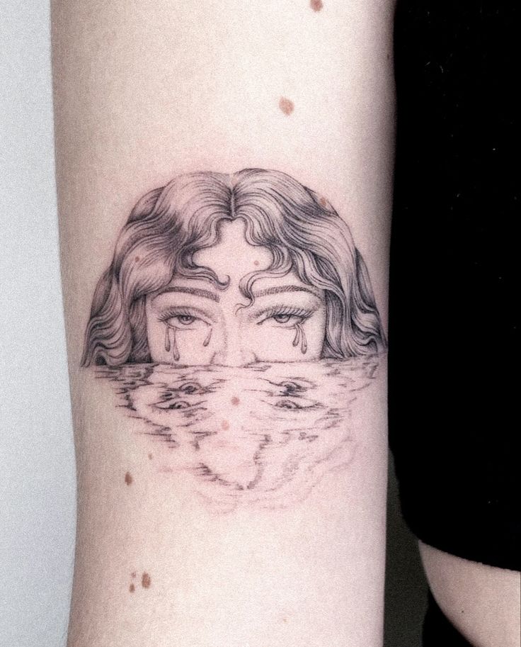 a woman's arm with a tattoo on it