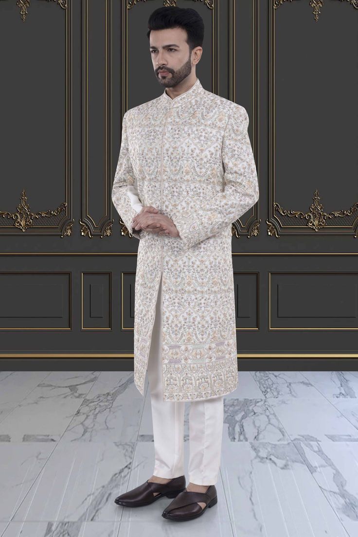 This groom sherwani, with elegant thread embroidery and shimmering stones, exudes luxury and sophistication. Elevate your special day with this exclusive piece, reminiscent of the finest art and literature. Make a statement and stand out as the most stylish groom in this Mens Sherwani, the perfect blend of tradition and modernity. Designer Resham Embroidery Kurta For Reception, Designer Kurta For Reception And Transitional Seasons, Designer Formal Traditional Wear With Chikankari Embroidery, Designer Traditional Wear With Chikankari Embroidery For Formal Occasions, Designer Chikankari Embroidery Formal Traditional Wear, Designer Chikankari Embroidery Traditional Wear For Formal Occasions, Reception Sherwani With Chikankari Embroidery In Raw Silk, Sherwani With Chikankari Embroidery In Raw Silk For Reception, Designer Nehru Jacket With Zari Work For Reception