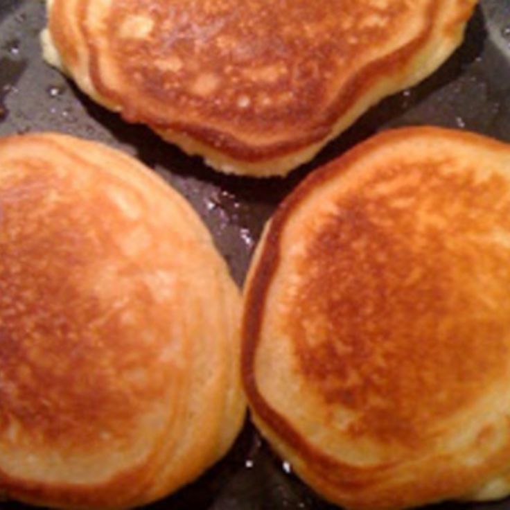 three pancakes are being cooked in a pan