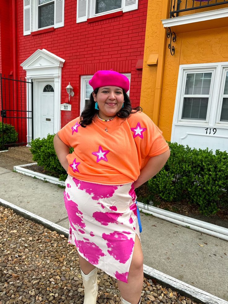 Bring on the glitz and glam with this oversized tee! This orange tee features pink stars that make you feel like a super star!!! Keep it casual with a pair of jeans or colorful pants, or dress it up with a pink skirt! This tee looks great with pinks, yellows, and blues! Oversized fit Style with jeans, colorful pants, or a cute skirt! This shade of orange looks great with pinks, blues, and yellows! True to size with an oversized fit 50% POLYESTER 37% COTTON 13% RAYON Imani is 5'3 and wearing a si Orange Pink Outfit, Businesses Photoshoot, Houston Photoshoot, Rainbow Closet, Colorful Photoshoot, Photoshoot Spring, Rainbow Clothes, Colorful Pants, Outfits Colorful