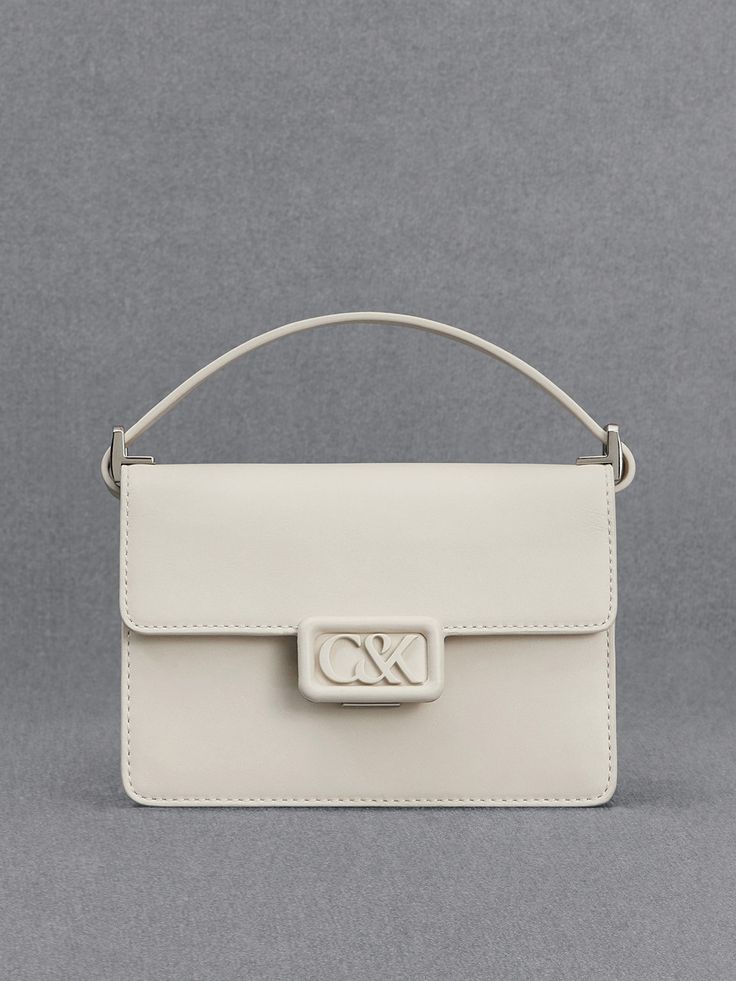 A polished and pristine all-white leather bag is an investment-worthy piece that deserves a spot in your capsule wardrobe - our boxy bag is a case in point. Made with genuine calf leather, this bag feels as luxurious as it looks. It opens up to a roomy main compartment that can hold your essentials and then some. The matching white hardware is polished and striking. Fitted with a thick shoulder strap that is also made with soft and supple leather, it will hang comfortably on your shoulder. Modern Box Bag With Branded Hardware For Office, Modern Office Box Bag With Branded Hardware, Chic Rectangular Box Bag With Branded Hardware, Designer White Rectangular Case Bag, Luxury White Rectangular Case Bag, Modern Top Handle Box Bag With Branded Hardware, Chic Rectangular Box Bag For Everyday Luxury, Chic Everyday Luxury Rectangular Box Bag, Luxury White Rectangular Shoulder Bag