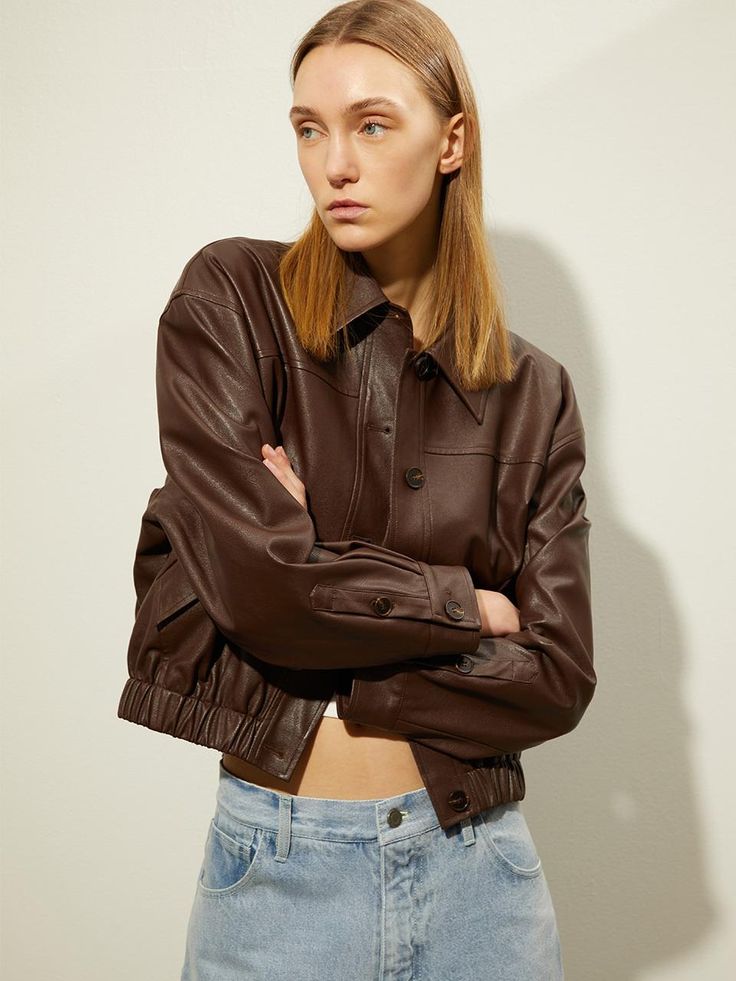 This semi-cropped silhouette blouson leather jumper combines daily practicality with a trendy mood. It features real buffalo horn buttons.- A banded hem detail for a comfortable and casual fit- Additional fabric at the back shoulder for enhanced wearability- The use of washed vegan leather ensuring lightweight comfort* Please note that the color may vary slightly depending on your monitor and smartphone model. Brown Leather Jacket With Button Cuffs For Fall, Brown Casual Cropped Jacket For Work, Casual Brown Cropped Jacket For Work, Cropped Leather Jacket With Pockets For Fall, Cropped Jacket With Button Cuffs For Fall, Casual Leather Jacket With Button Cuffs For Fall, Cropped Tops With Button Cuffs For Fall, Brown Leather Top For Fall, Classic Brown Cropped Jacket For Fall