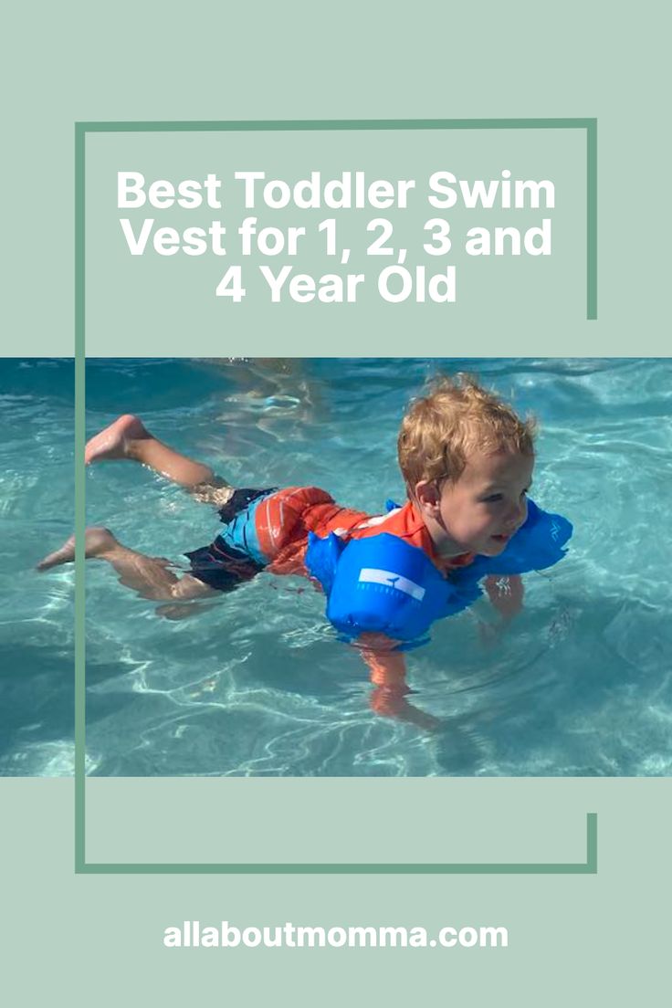 a young boy swimming in the pool with an inflatable life jacket on his back