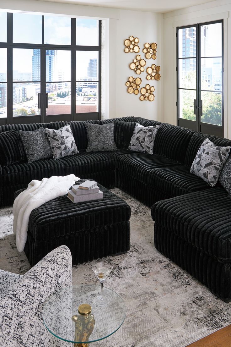 a living room filled with black and white furniture