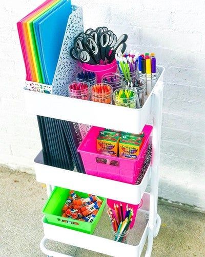 three tiered storage rack with pens, pencils, markers and other office supplies