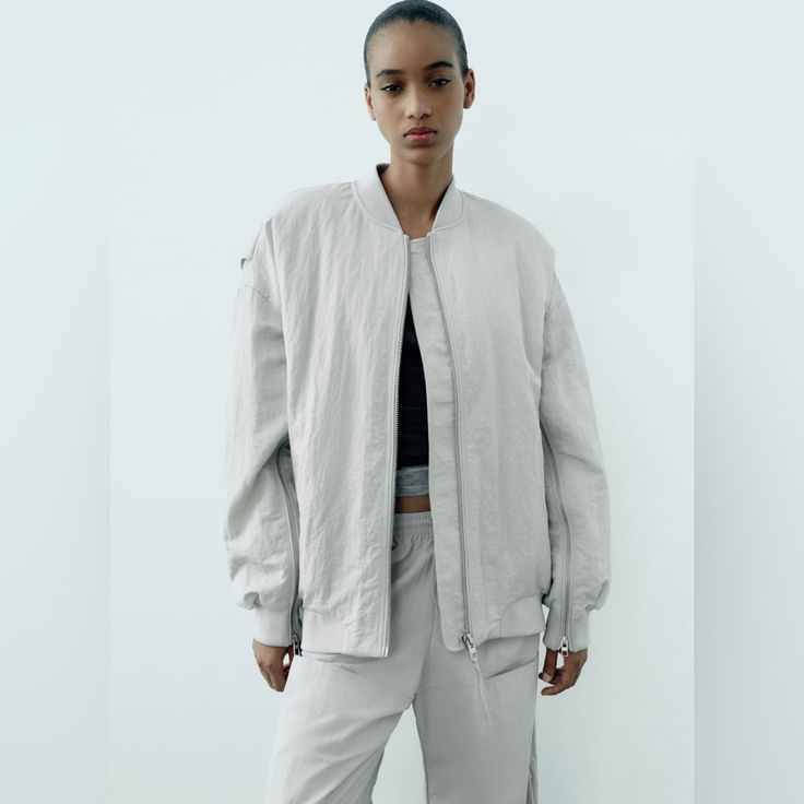 Love This Look! The Color Is A Gorgeous Light Gray, Almost Silvery Hue. Oversized & Extremely Comfortable! Water Repellent , Round Neck & Long Sleeves. Zipper Details , Love The Zippers On The Sleeves. Looks Super Cute With Jeans Or Leggings. Perfect For Everyday On The Go! Bomber Jacket Oversized Boyfriend Zip Front Water Repellent Oversized Spring Windbreaker For Streetwear, Urban Spring Track Jacket For Workwear, Urban Relaxed Fit Outerwear For Spring, Oversized Spring Windbreaker, Urban Outerwear With Ribbed Cuffs For Spring, Relaxed Fit Track Jacket For Workwear In Spring, Oversized Casual Track Jacket For Work, Zara Casual Outerwear With Ribbed Cuffs, Spring Outerwear With Ribbed Cuffs