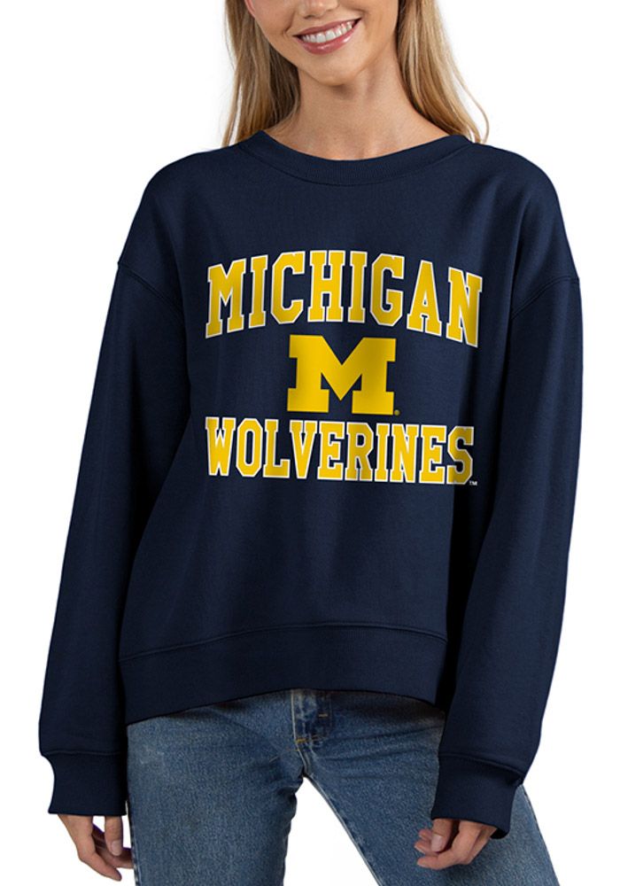 Make your way to the big game in this Michigan WolverinesWomens Navy Blue Old School Crew Sweatshirt! This Wolverines Long Sleeve Sweatshirt features a screen print team name and logo on center chest. Stay warm and comfortable with this Womens Michigan Wolverines Crew Sweatshirt. Long sleeve, Crew neck, Finished hem, High low bottom hem, 60% COTTON / 40% POLYESTER, 4 Collegiate Tops With University Logo For Game Day, Sporty Tops For Campus During Sports Season, Navy Varsity Top For College, Navy Collegiate Crew Neck Top, Collegiate Navy Top For Game Day, Collegiate Fall Fan Gear Tops, Navy Collegiate Top For College, Long Sleeve University Logo Tops For Sports Season, Navy Collegiate Style Top