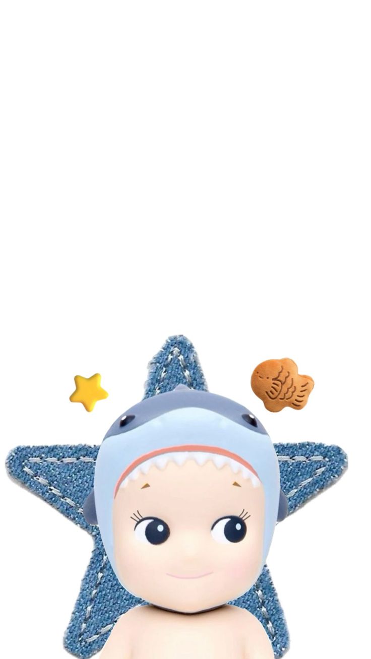 a small doll with blue hair and stars on it's head, sitting in front of a white background