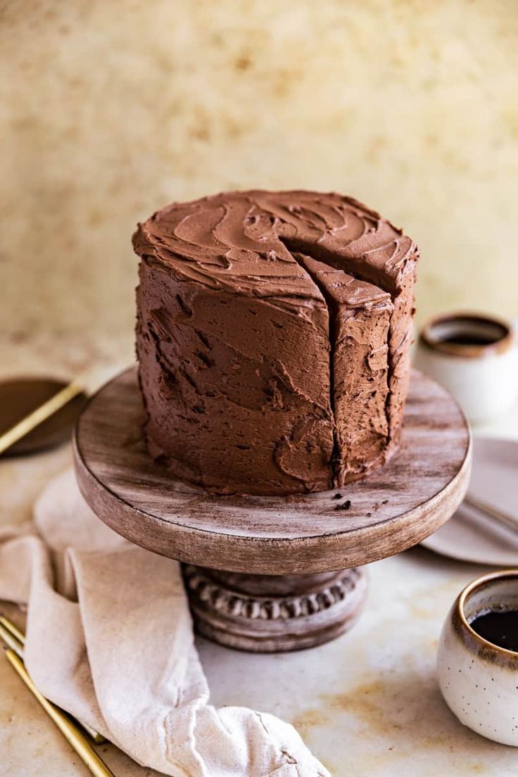 a chocolate cake sitting on top of a wooden plate