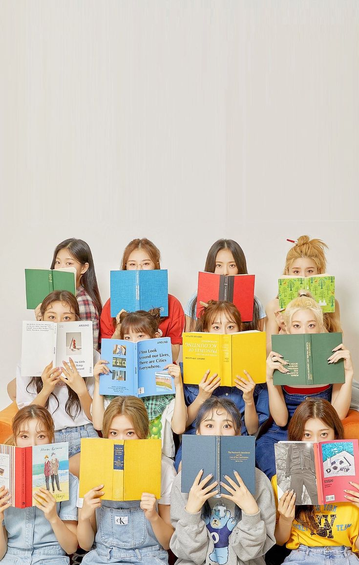 a group of children holding books in front of their faces