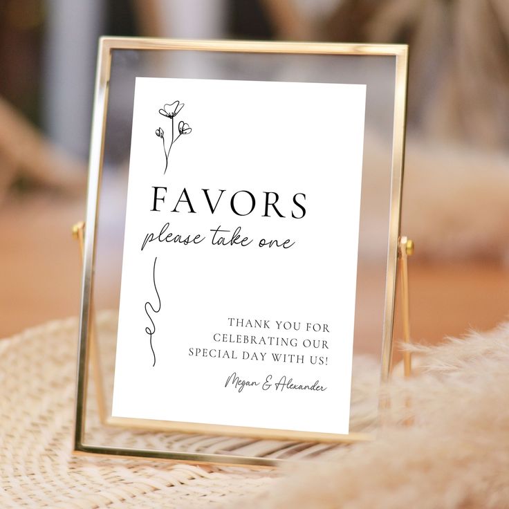 a sign that says favors please take one with a gold frame and floral design on it