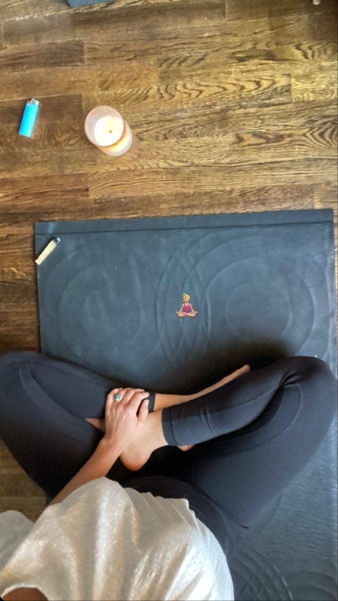 a woman laying on top of a yoga mat