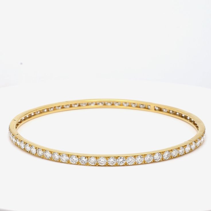 Title: 9.75 Carat Diamond 18 Karat Yellow Gold Bangle Bracelet Style: Bangle Metal: 18 Karat Yellow Gold Gemstone 1: 9.75 Carat Diamond Number of Stones: 65 Color: G Clarity: VS1 Shape: Round Brilliant Dimension: 7-3/4in X 3.5mm Weight: 11.8 Grams Condition: Vintage And Estate Product ID: R21J58 Note: Please note that all the non-GIA Gemstones' Weight, Color, Cut, and Clarity are estimated values to the best of our knowledge. Timeless Diamond Bracelet With Channel Set For Formal Occasions, Timeless Channel Set Diamond Bracelet For Formal Occasions, Timeless Channel Set Diamond Bracelet For Formal Events, Luxury Channel Set Bracelets For Anniversary, Luxury White Gold Bracelet Channel Set, Luxury White Gold Bracelets Channel Set, Luxury White Gold Channel Set Bracelets, Luxury Tennis Bracelet With Channel Set For Formal Occasions, Luxury Channel Set Diamond Bracelet