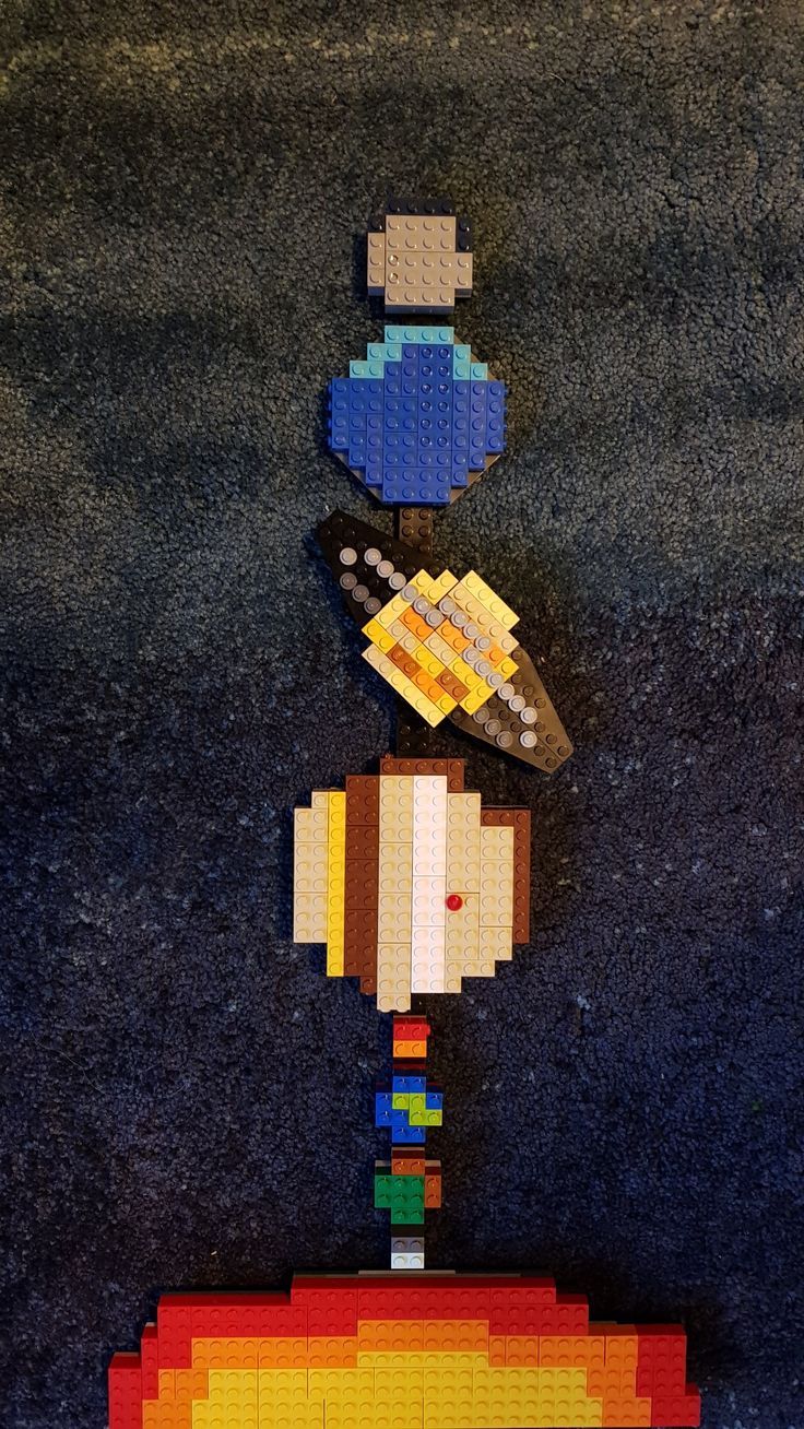 a woman's head made out of legos on top of a black surface