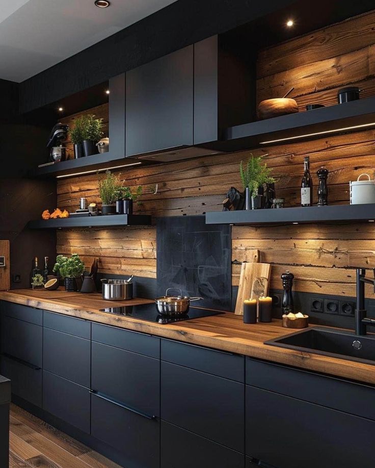 a kitchen with wooden walls and black cabinets, potted plants on the counter top