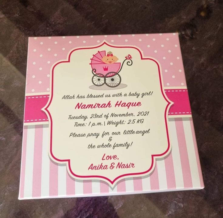 a pink and white card with a baby carriage on it