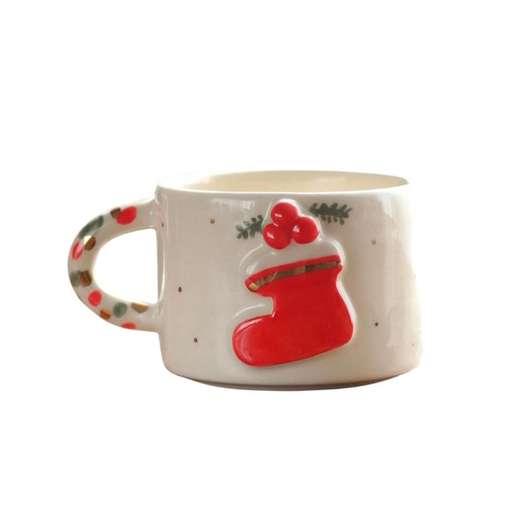 a white mug with a red christmas stocking on it