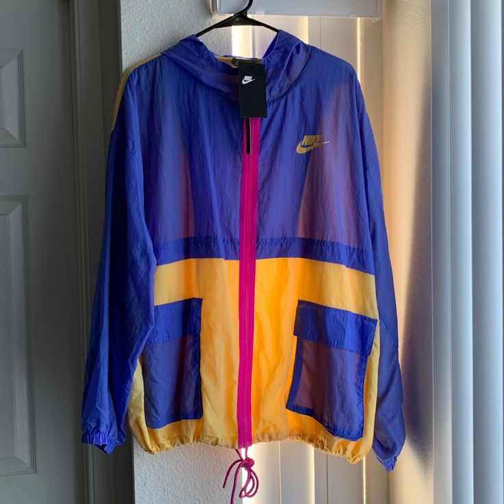 Nwt Purple/Pink/Yellow Color Blocked Nike Windbreaker. Never Worn. Can Cinch The Bottom. Multicolor Hooded Color Block Windbreaker, Multicolor Color Block Hooded Windbreaker, Multicolor Hooded Windbreaker With Color Block, Casual Pink Patchwork Windbreaker, Casual Multicolor Patchwork Windbreaker, Spring Nylon Color Block Outerwear, Sporty Pink Patchwork Outerwear, Color Block Long Sleeve Windbreaker For Spring, Multicolor Nylon Windbreaker With Pockets