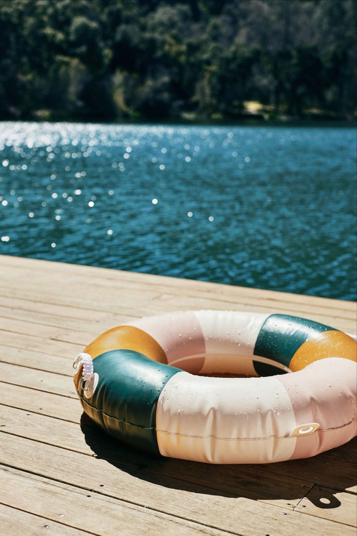 an inflatable life preserver sitting on a wooden dock