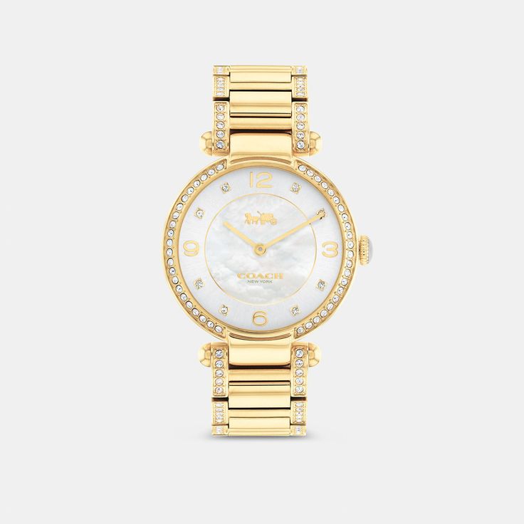 Timeless and elegant the Cary watch is a sophisticated style perfect for day or night. The gold tone bracelet design shimmers with crystals and features a luminous mother-of-pearl dial with our iconic Horse and Carriage motif for a heritage touch. | Coach Cary Watch, 34 Mm - Women's - Gold Elegant Gold-tone Watch With Round Dial, Classic Gold Coach Watch, Elegant Coach Jewelry With Polished Finish, Gold Coach Watch With Metal Dial, Coach Gold Watch With Metal Dial, Coach Gold Watches With Metal Dial, Classic Gold-tone Watch With Round Dial, Luxury Coach Watches With Diamond Hour Markers, Luxury Coach Watches With Polished Finish