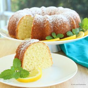 a lemon bunt cake with powdered sugar and fresh mint on the side, ready to be eaten