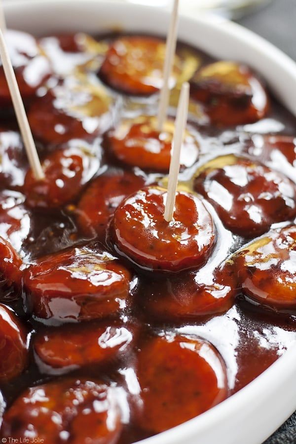 some toothpicks are sticking out of the meatballs in a dish with sauce