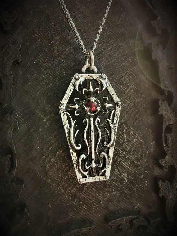 This gothic coffin necklace is an handmade pewter sculpture with a gemstone of your choiceThis Coffin Pendant is sold with a free 18'' stainless steel chain, if you would like to have a different lenght for the chain, you can write the desired lenght in the private note section when ordering :)The little coffin is 3.5cm top to bottomThis Gothic Coffin is a pewter sculpture of my own creation, i create and work the metal by myself at home. The material used is the finest and highest grade hypoall Gothic Hand-cast Halloween Necklaces, Gothic Cross Pendant Jewelry For Halloween, Gothic Hand Forged Pendant Necklace, Gothic Pendant Necklace With Antique Finish, Gothic Hand Cast Collectible Necklaces, Medieval Jewelry For Halloween Gift, Cross-shaped Halloween Jewelry Gift, Gothic Metal Necklace With Antique Finish, Gothic Nickel-free Necklaces