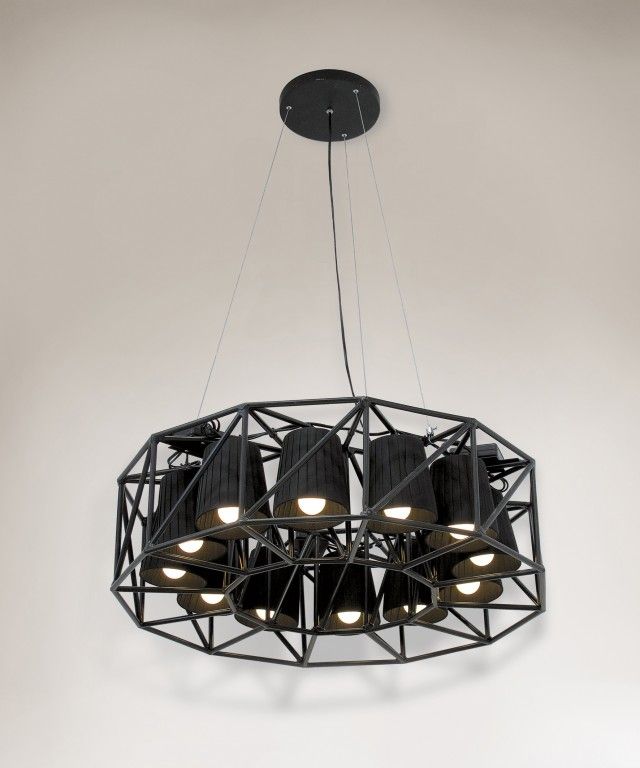 a circular chandelier with six lights hanging from it's center, in an empty room