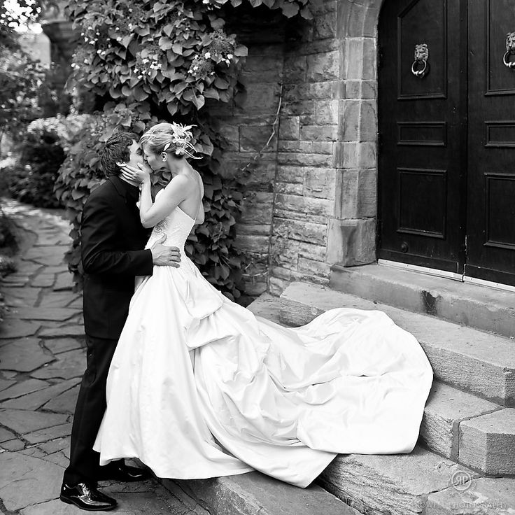 a bride and groom kissing on the steps