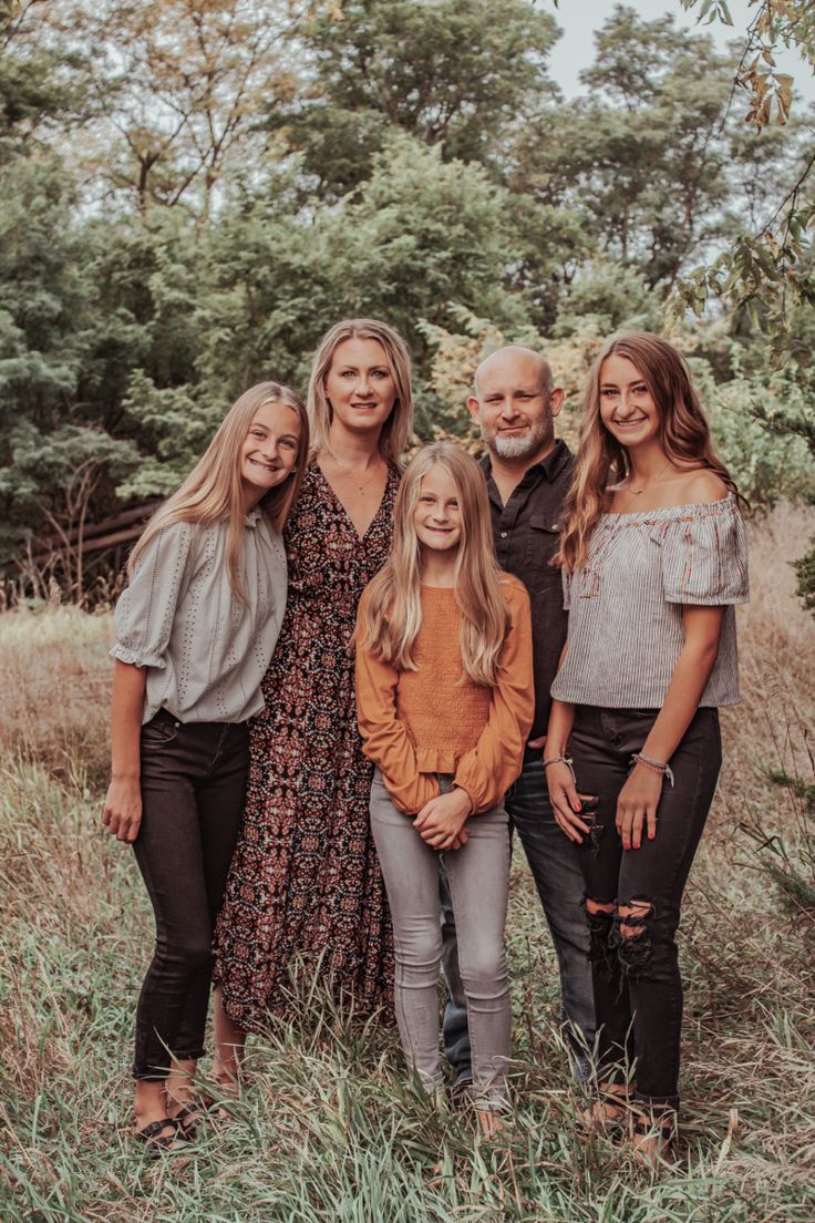 a family posing for a photo in the grass