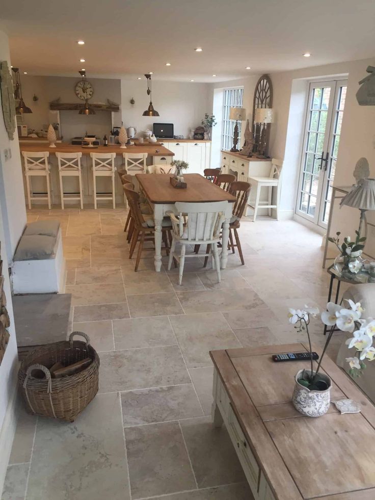 a kitchen and dining room are shown in this image from the living room looking into the open floor plan