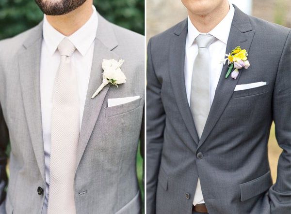 two men in suits and ties one is wearing a boutonniere the other has a flower on his lapel