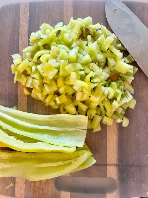 chopped up vegetables on a cutting board next to a knife