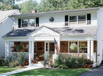 a white house with an american flag on the front porch