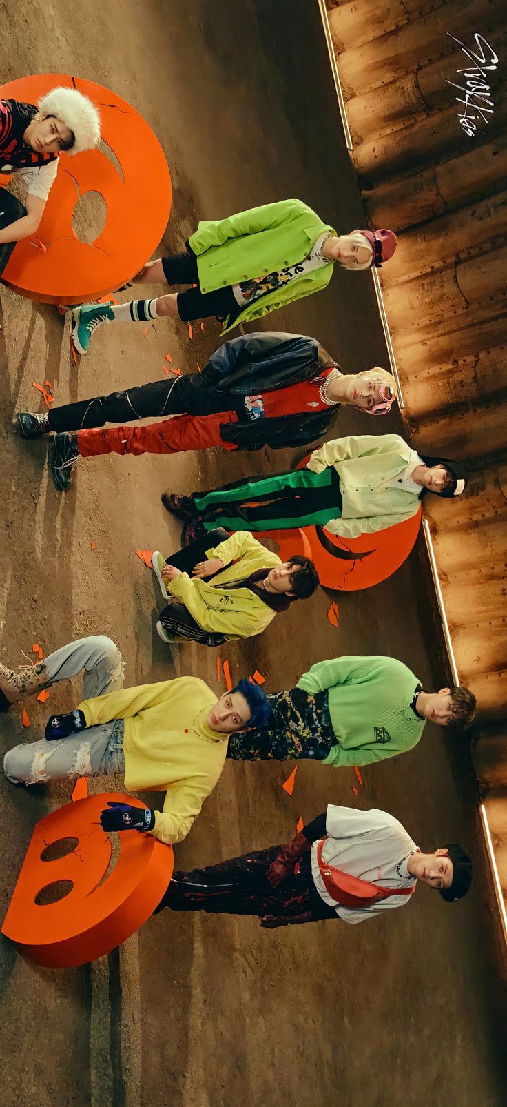 a group of people standing next to each other in front of an orange sign that says 8