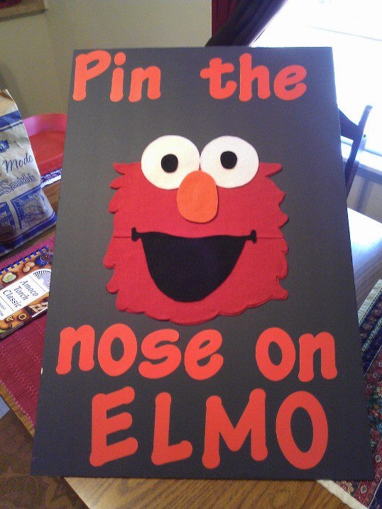 a sign that says pin the nose on elmo